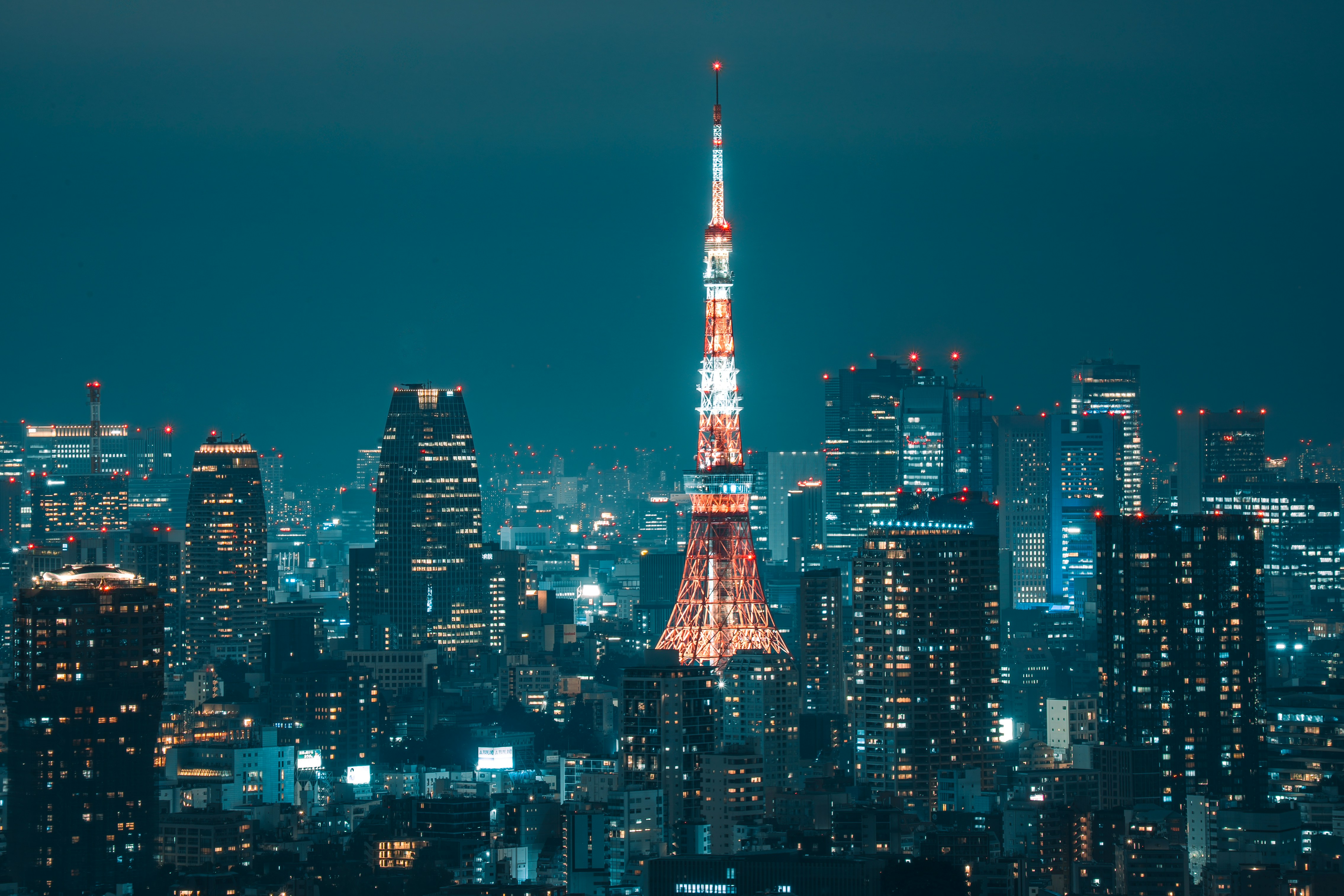 Tokyo Tower illuminated against the city skyline at night